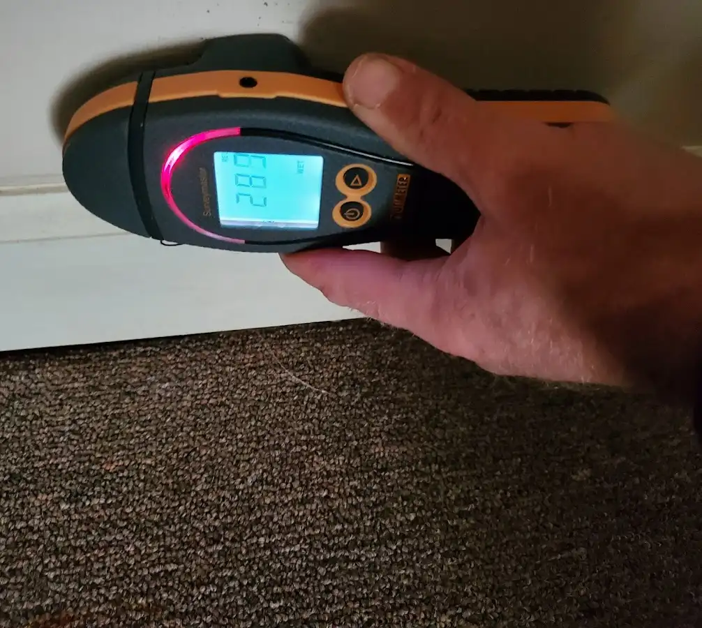 Moisture detection at baseboard during Storm Damage Restoration in Ecorse
